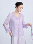 Side view of a women's light purple Tencel cardigan featuring delicate butterfly embroidery, a V-neckline, and long sleeves, with a relaxed and elegant fit.