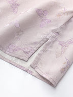 Close-up of a light purple 23 momme silk fabric featuring delicate butterfly jacquard patterns and subtle floral details, 94% mulberry silk blend.
