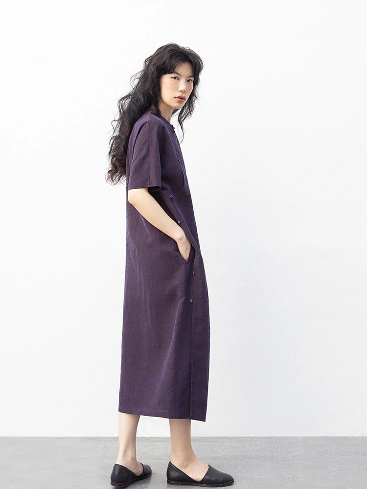 Side view of a purple mulberry silk qipao dress showing its relaxed ankle-length silhouette and side opening.