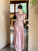 Model wearing a purple shiny maxi skirt with a matching embroidered top, showcasing the lustrous finish and comfortable fit.