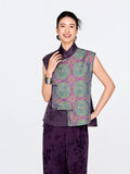 Front view of a woman wearing the purple mulberry silk vest with turquoise, blue and gold Shu brocade medallions.