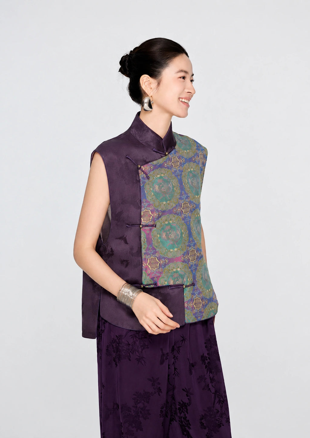 Side view of the purple Shu brocade silk vest featuring a stand collar, asymmetric panel and traditional frog closures.