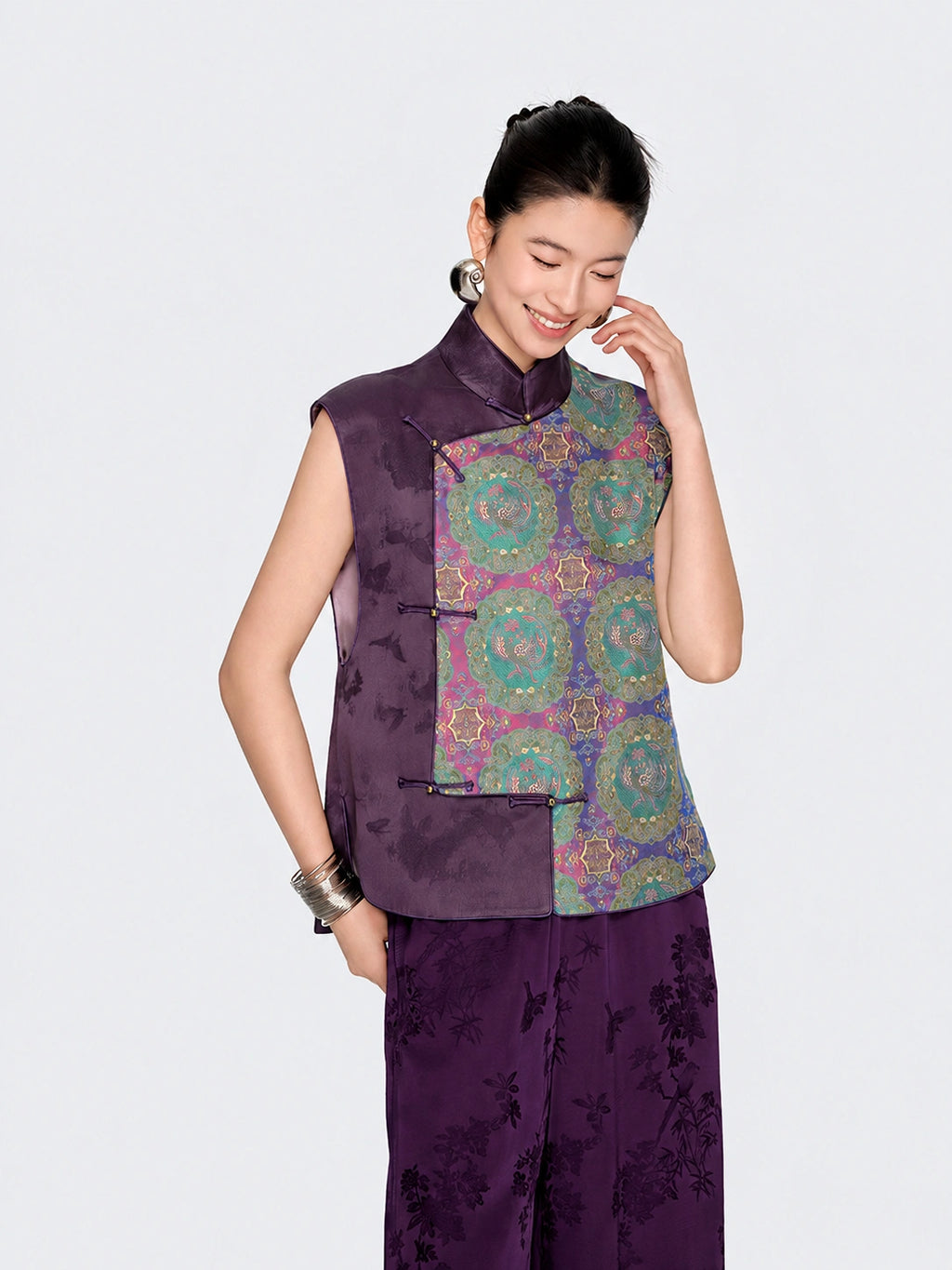 Three-quarter front view of the purple New Chinese silk vest with jewel-toned Shu brocade detailing.