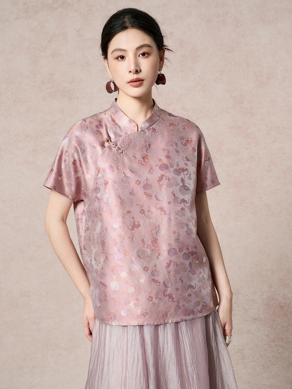 Front view of a purple silk top featuring a traditional stand collar and a delicate side frog button detail, highlighting the subtle sheen of the fabric.