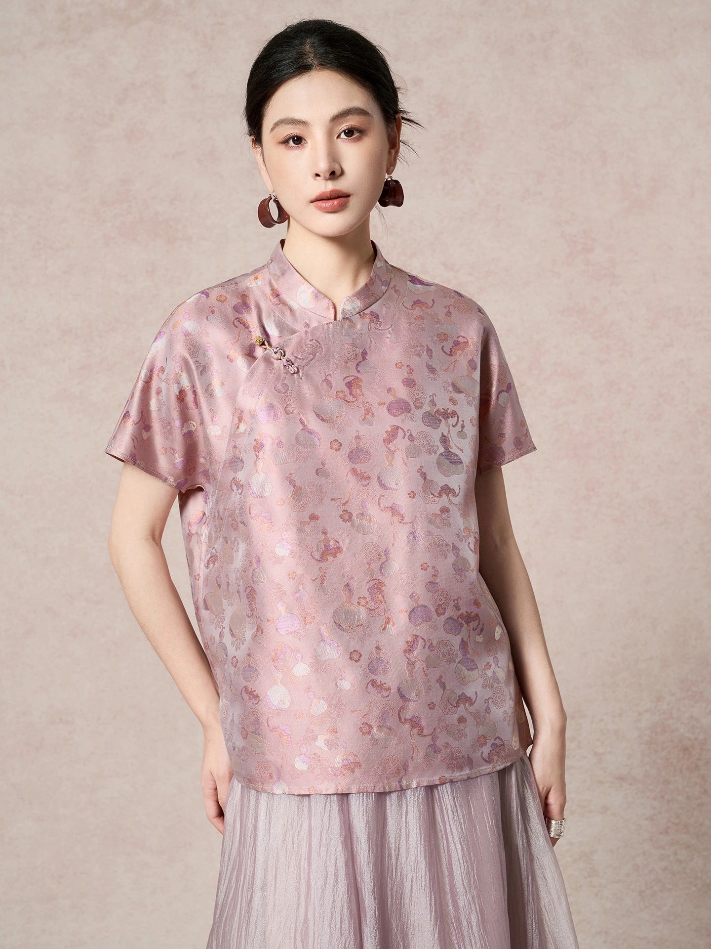 Front view of a purple silk top featuring a traditional stand collar and a delicate side frog button detail, highlighting the subtle sheen of the fabric.