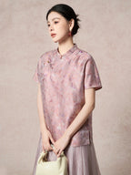 Model wearing a purple silk Cheongsam top with a relaxed fit, holding a cream handbag, showcasing the elegant drape and lustrous sheen.