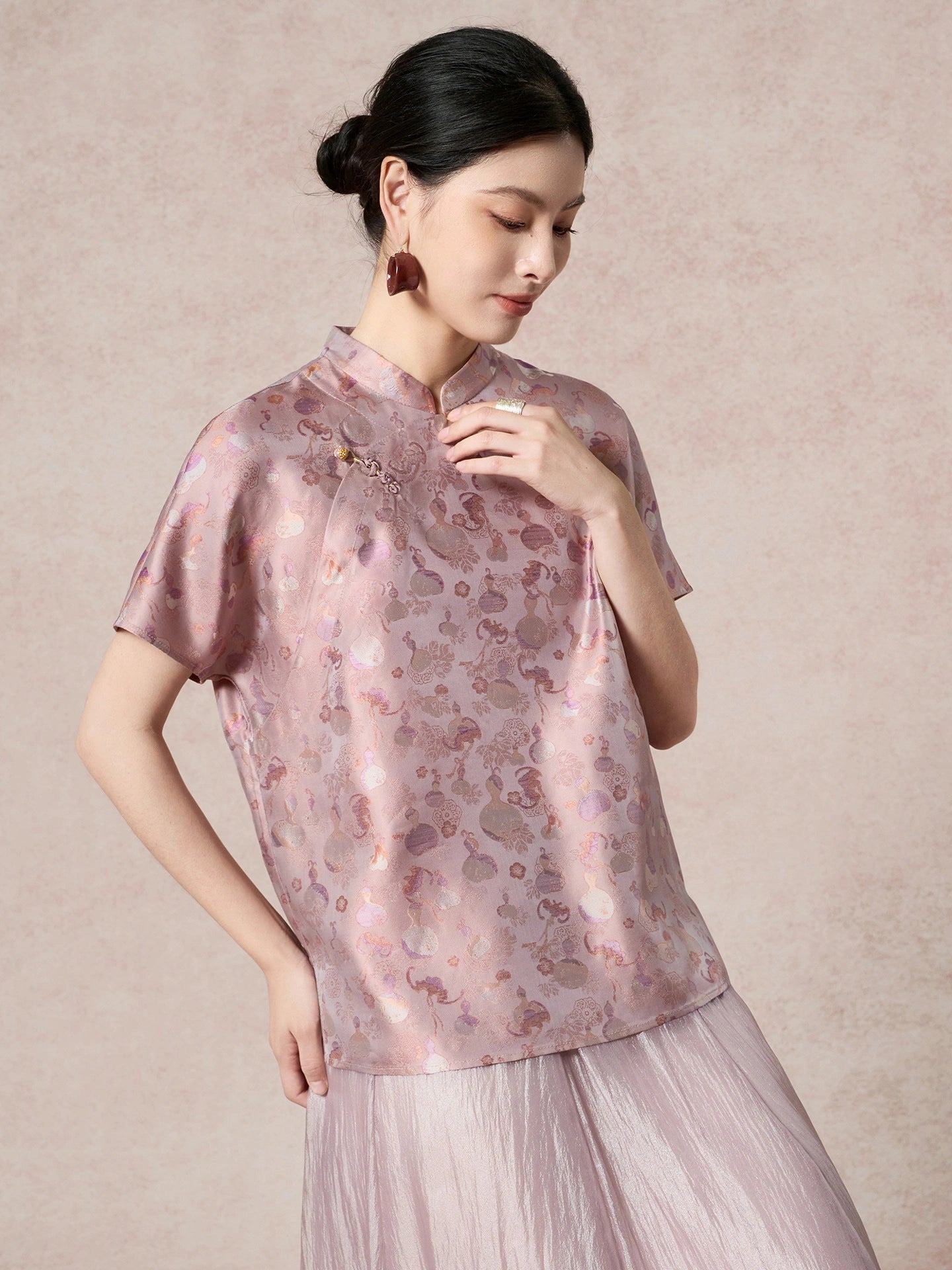 Close-up of a purple 100% mulberry silk Cheongsam top featuring a delicate stand collar and a traditional frog button closure.