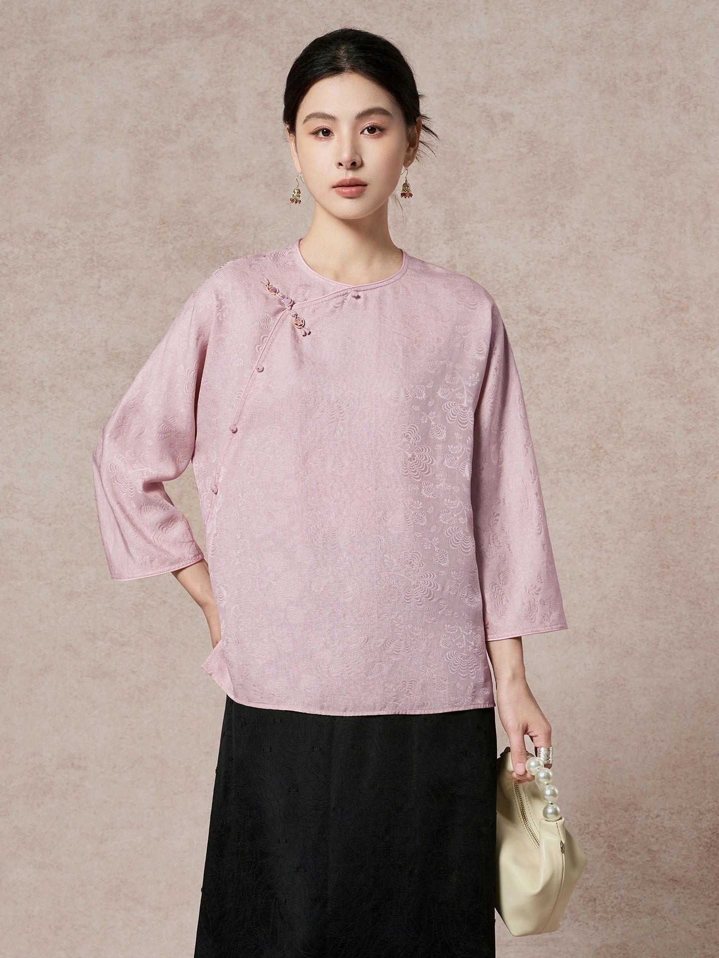Model wearing a light purple 93.8% mulberry silk blouse with a round neckline, diagonal placket, and intricate jacquard weaving, paired with a black skirt, showcasing a sophisticated New Chinese style look.