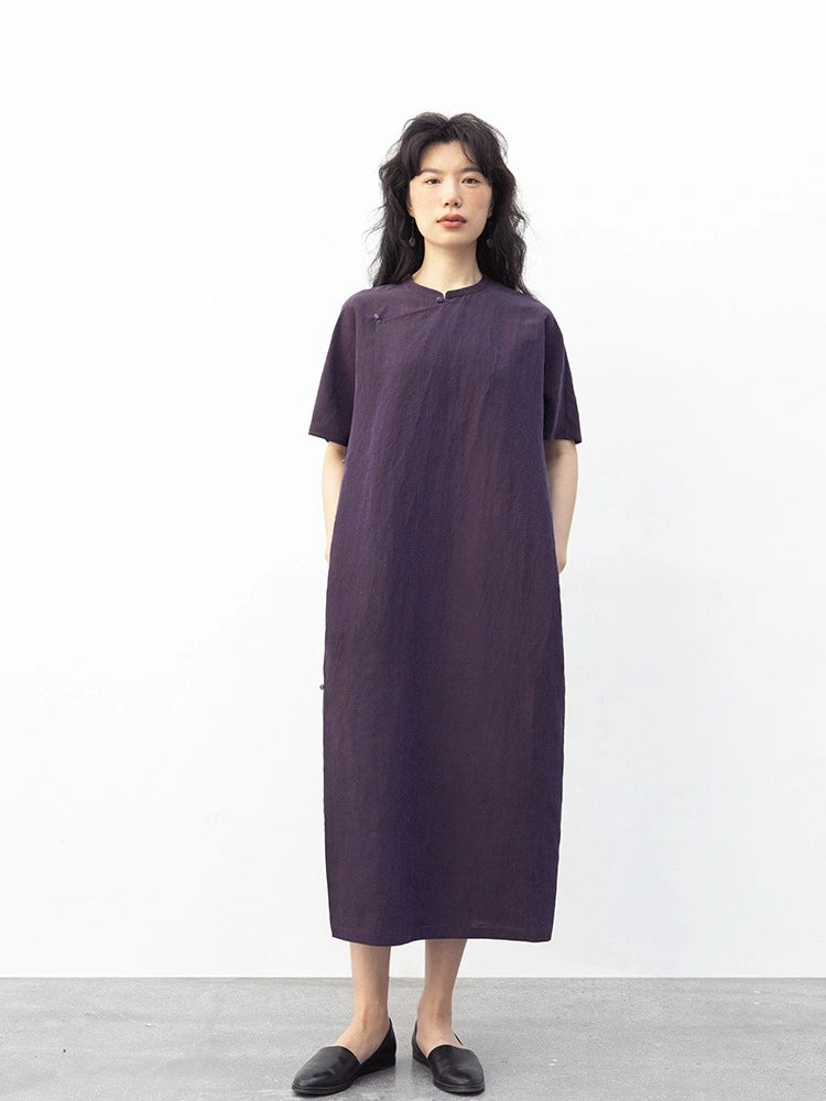 Front view of a model wearing a purple 100% mulberry silk modern qipao dress with short sleeves and side pockets.