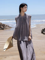 Woman wearing a grey ramie lyocell sleeveless top and maxi skirt two-piece set at the beach.