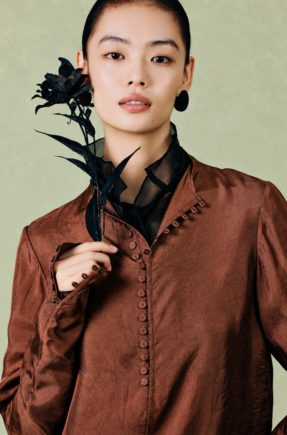 Close-up of the shirt’s covered front buttons, cuff details and tonal fabric texture.