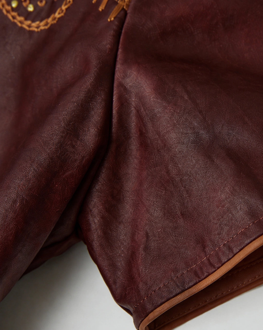 Close-up of the lustrous wine-red Hongyunsha fabric, short sleeve and contrast piping
