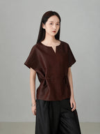 Women wearing a red Xiangyunsha silk top featuring modern oriental style, breathable natural silk fabric, and minimalist luxury design.