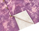 Close-up showing the jacket’s purple floral side and contrasting ivory jacquard reverse.
