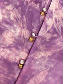 Close-up of the purple floral jacquard and pearl-tone buttons with gold-tone accents.
