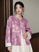 Model wearing the purple floral jacket with visible patch pockets and contrasting ivory cuffs.