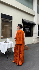 Back view of a rust orange Cheongsam vest set, showcasing the jacquard texture of the 100% viscose pants.