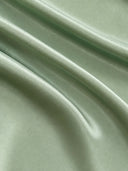 Close-up of the smooth sage green acetate and mulberry silk blend fabric