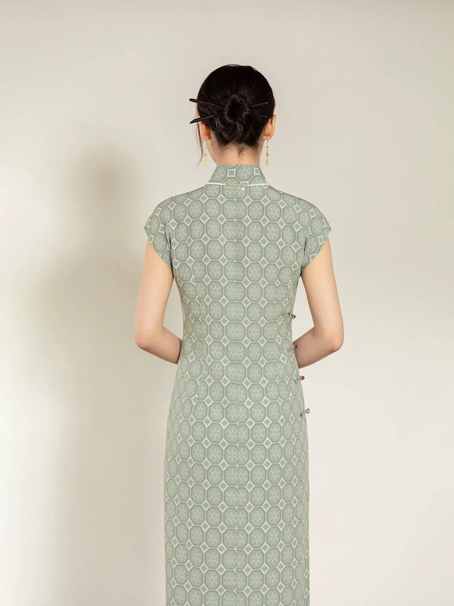 Full back view of the sage green jacquard cheongsam dress with Mandarin collar.