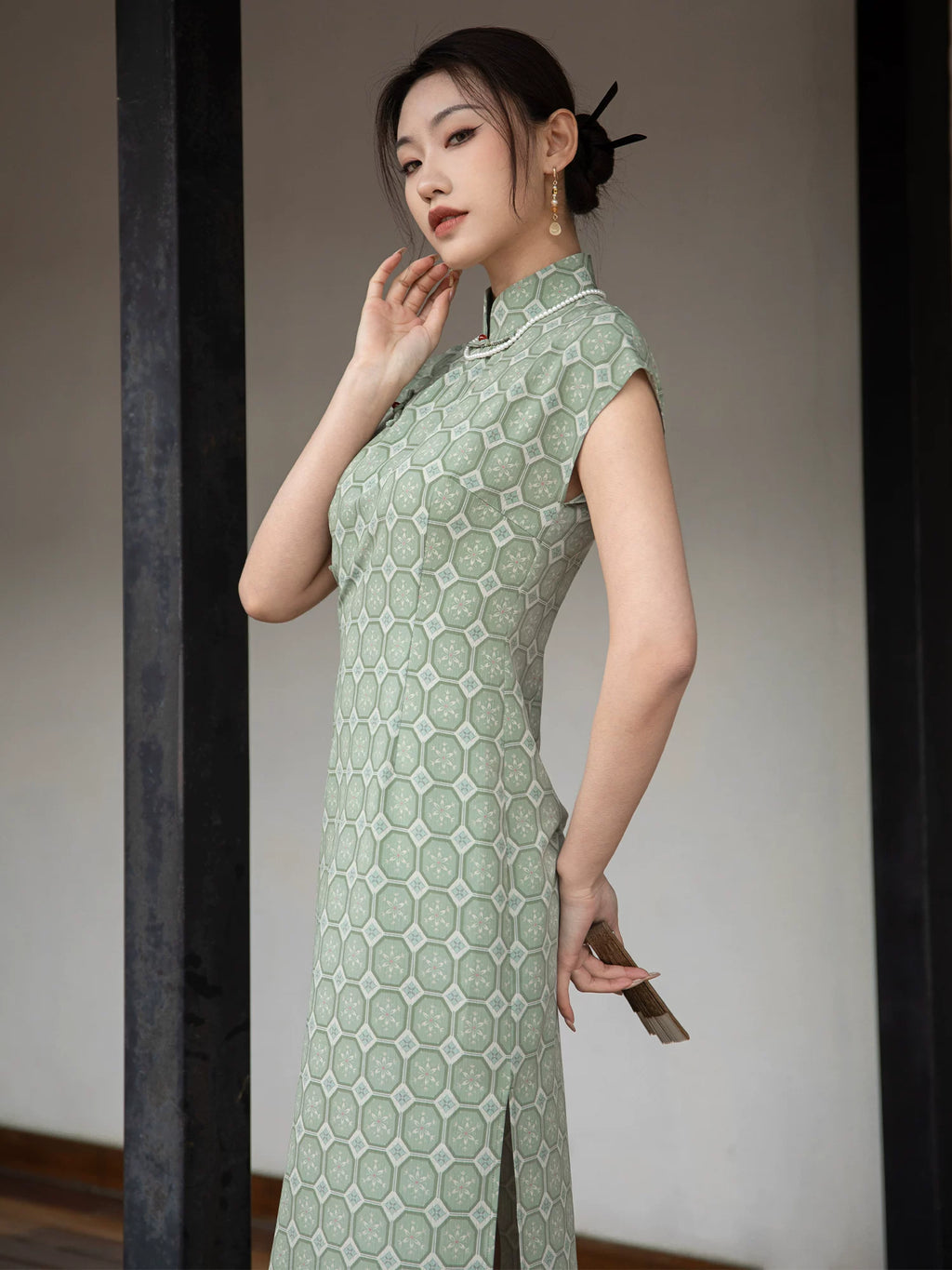 Side view of the sage green jacquard cheongsam dress showing the fitted silhouette and woven texture.