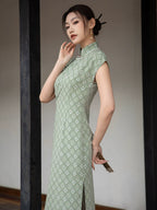 Side view of the sage green jacquard cheongsam dress showing the fitted silhouette and woven texture.