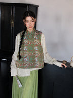 Front view of a sage green Chinese-style silk vest featuring a stand collar and traditional dragon and phoenix motifs.