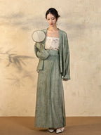 Full-length look of the Sage Green Draped Sleeve Jacket and Wrap Skirt Set.