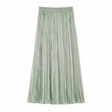Flat lay of a sage green pleated maxi skirt with an elastic waistband and full length, crafted from 80% Lyocell, 20% Polyester.