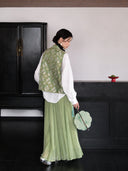 Back view of a sage green Songjin silk Chinese vest featuring an all-over rabbit motif and stand collar.