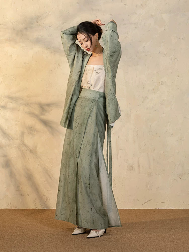 Back detail of the Sage Green Draped Sleeve Jacket paired with the flowing wrap skirt.