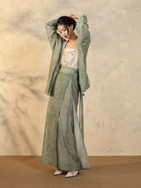 Back detail of the Sage Green Draped Sleeve Jacket paired with the flowing wrap skirt.