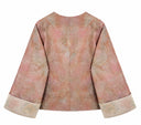Back view of the peach patterned jacket with embroidered cuffs