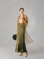 Woman wearing a sheer tea brown organza long cover-up over an elegant dress.