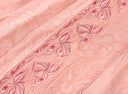 Close-up of the floral embroidery along the blouse’s front panel.