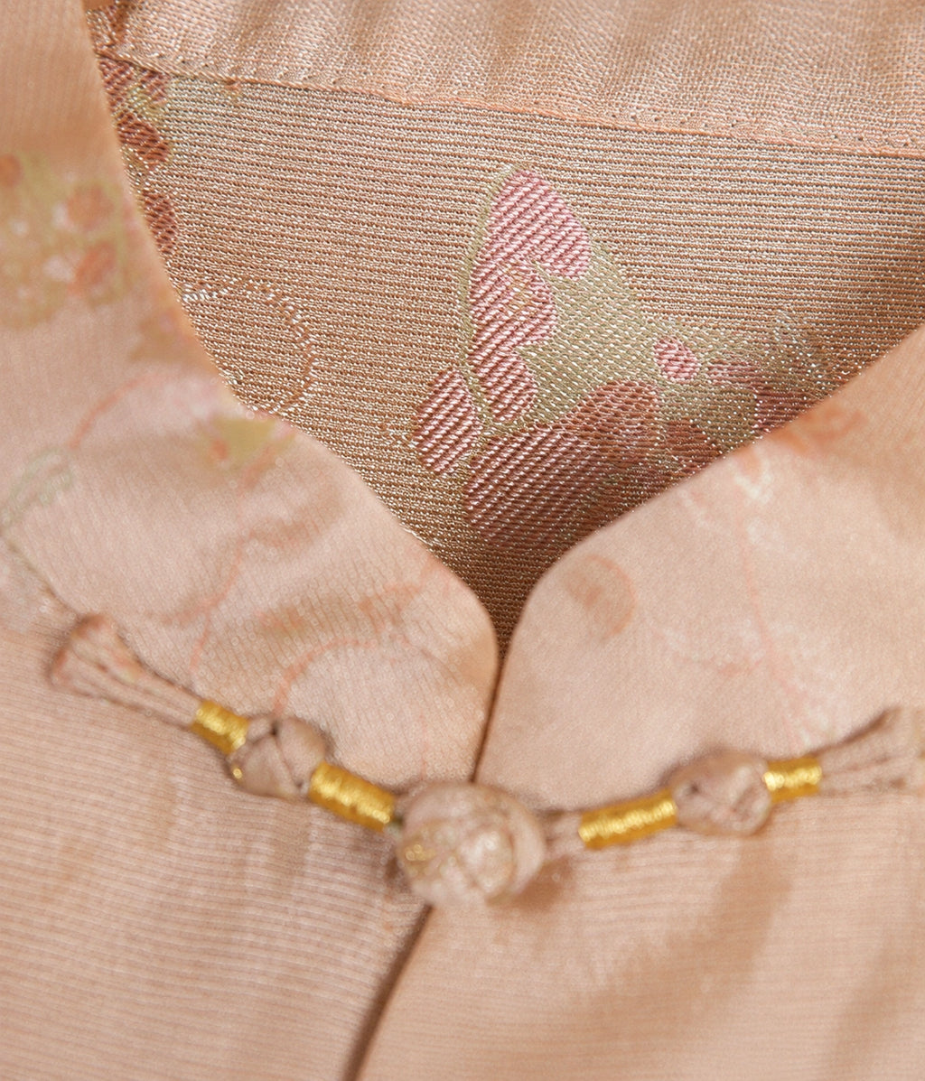 Close-up of the Mandarin collar, handmade frog button and butterfly jacquard pattern on blush pink silk