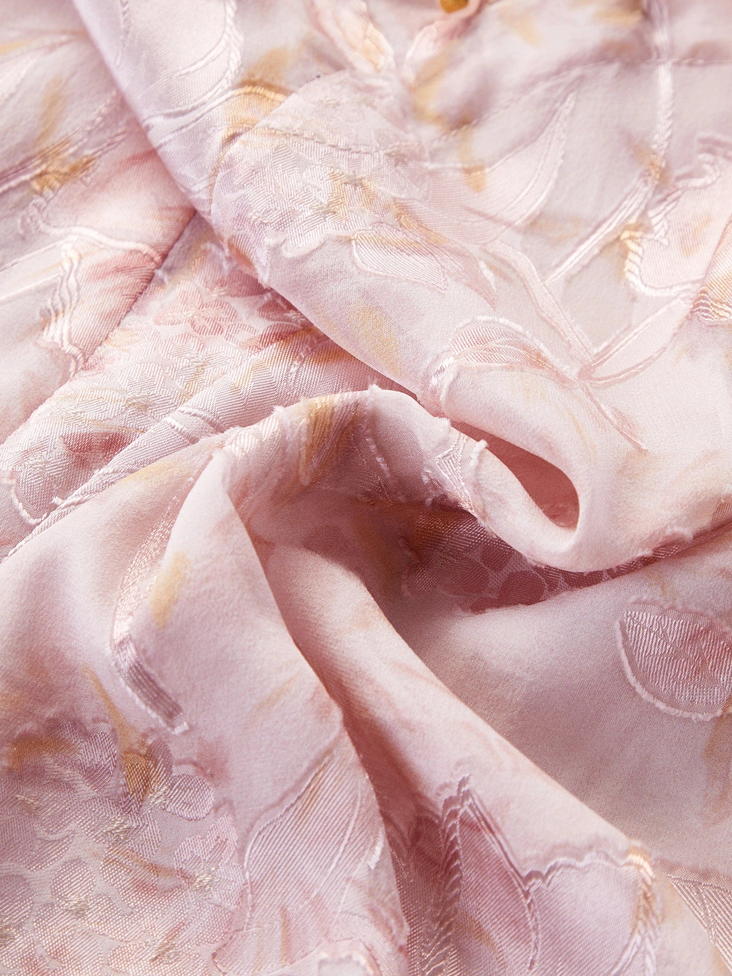 Close-up of the 100% silk chiffon fabric showing the intricate floral cutwork and subtle sheen, highlighting the premium quality.