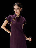 Close-up of the mandarin collar and frog button details on the silk qipao.