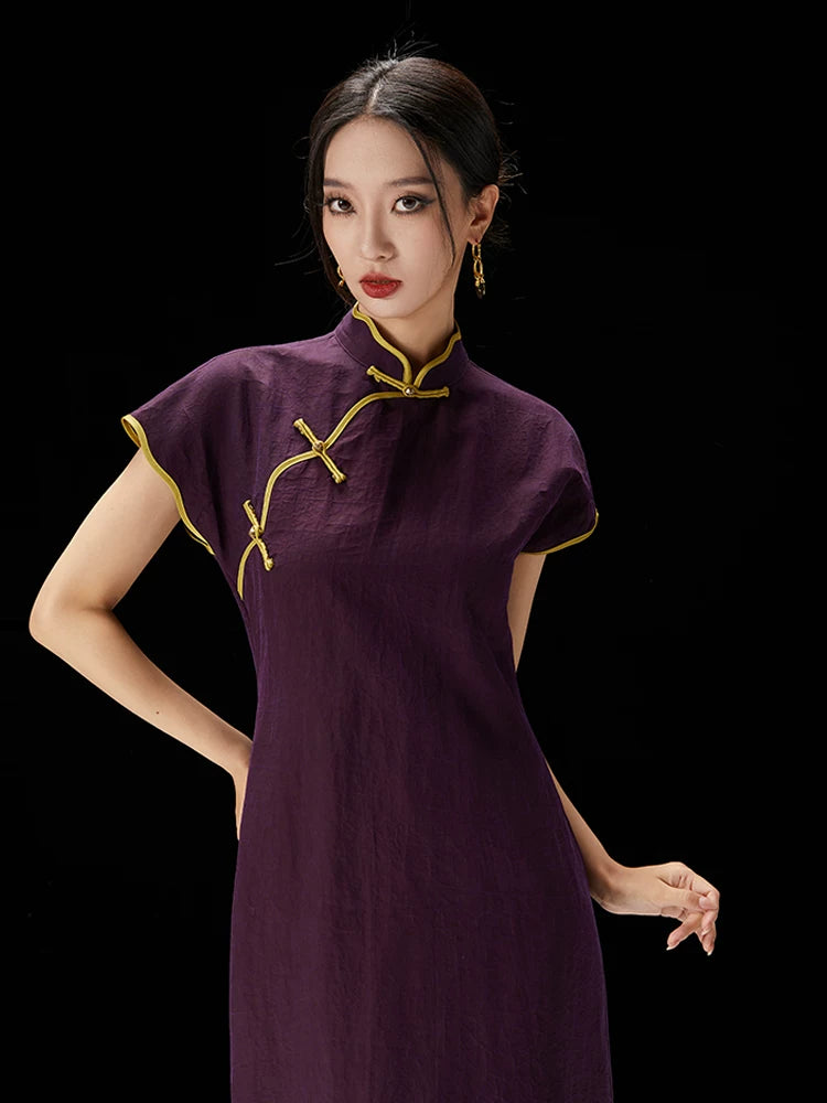 Close-up of the mandarin collar and frog button details on the silk qipao.