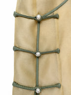 Close-up of the side placket with three pearl-style frog buttons on champagne yellow silk