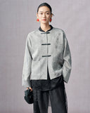 Front view of a silver-grey floral jacquard jacket with contrast clasps and patch pockets