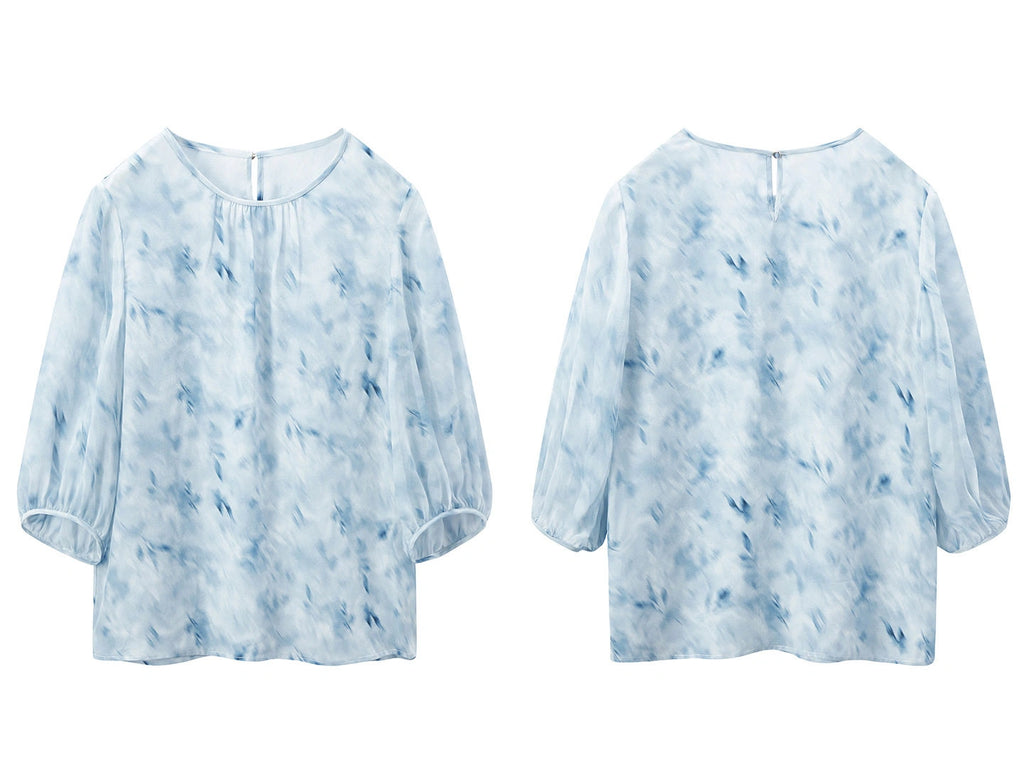 Front and back product view of a sky blue printed silk blouse with three-quarter sleeves