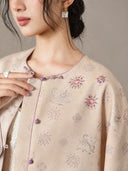 Close-up of the jacket’s violet buttons, bead-accented floral motifs and small animal pattern