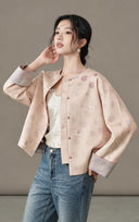 Model styling the open blush jacquard jacket with a light top and denim
