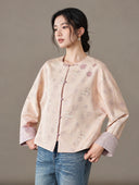 Angled view of the model wearing the buttoned blush jacket with jeans