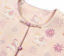 Close-up of the round neckline, knotted closure and violet bead embellishment