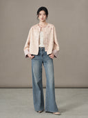 Full-length model view of the jacket worn open over a light top with jeans