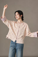Model wearing the jacquard jacket with jeans and both arms raised