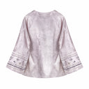 Back view of the smoky pink jacquard jacket with wide floral embroidered cuffs.