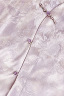Close-up of the jacket’s diagonal front, pink buttons and tonal floral-and-cloud pattern.