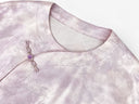 Close-up of the round neckline and decorative knot closure on the smoky pink jacket.